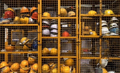 a rack filled with lots of yellow hard hats