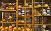a rack filled with lots of yellow hard hats