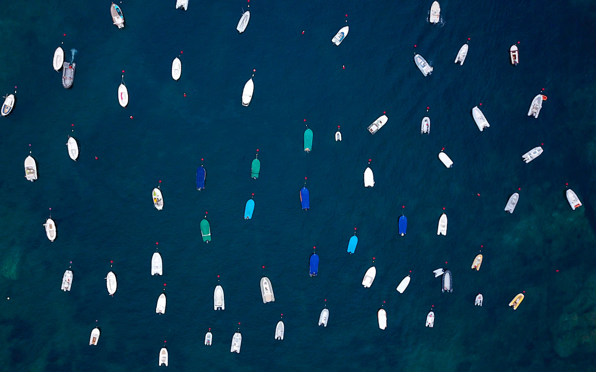 Yacht seen from above in jewel-blue Mediterranean water