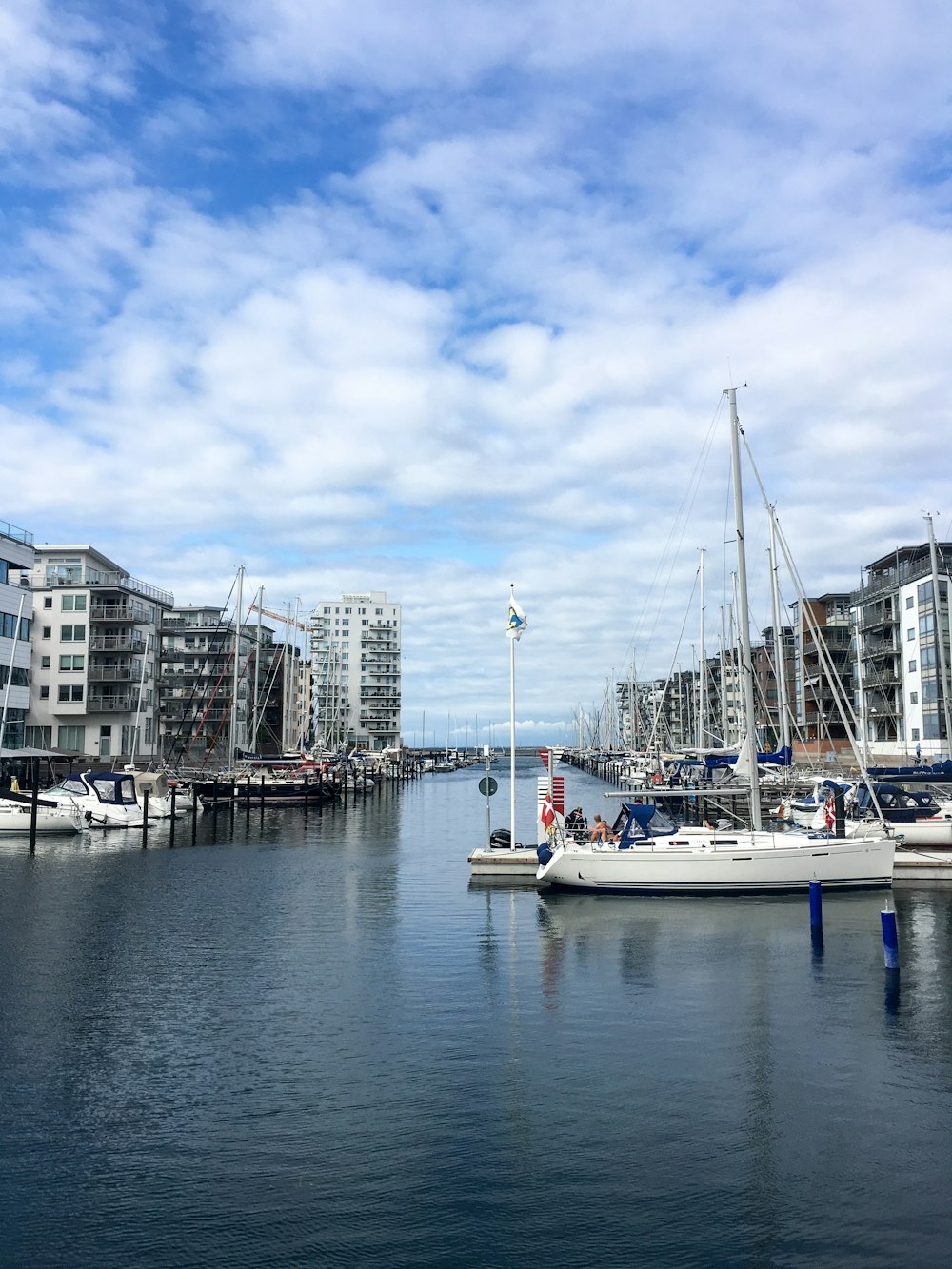 white motorboat dock near buildings