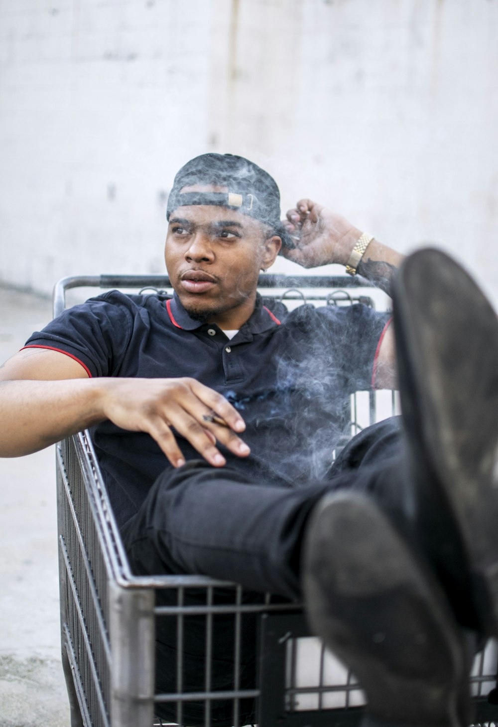 man sits inside shopping cart