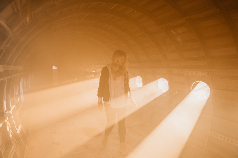 woman standing inside room with spotlights