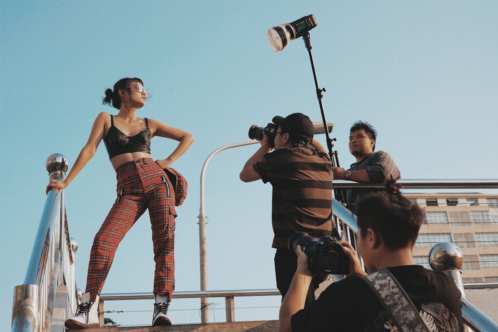 woman standing near metal bar