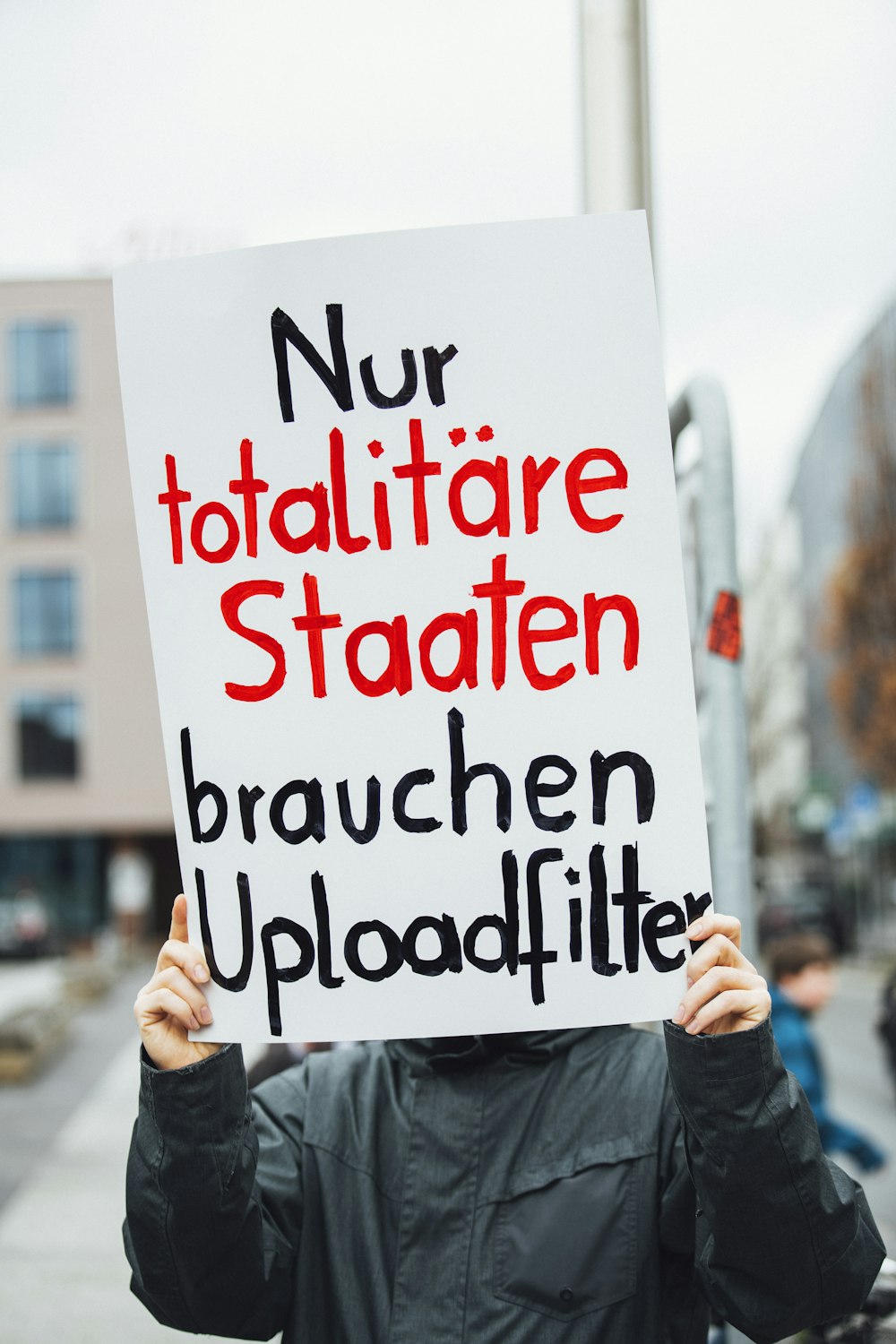 person holding white signboard