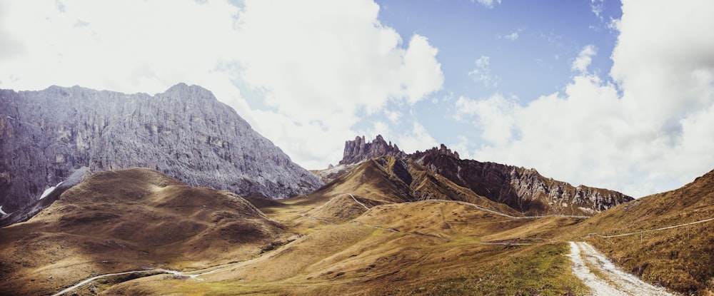 vast land under cloudy blue sky during daytime