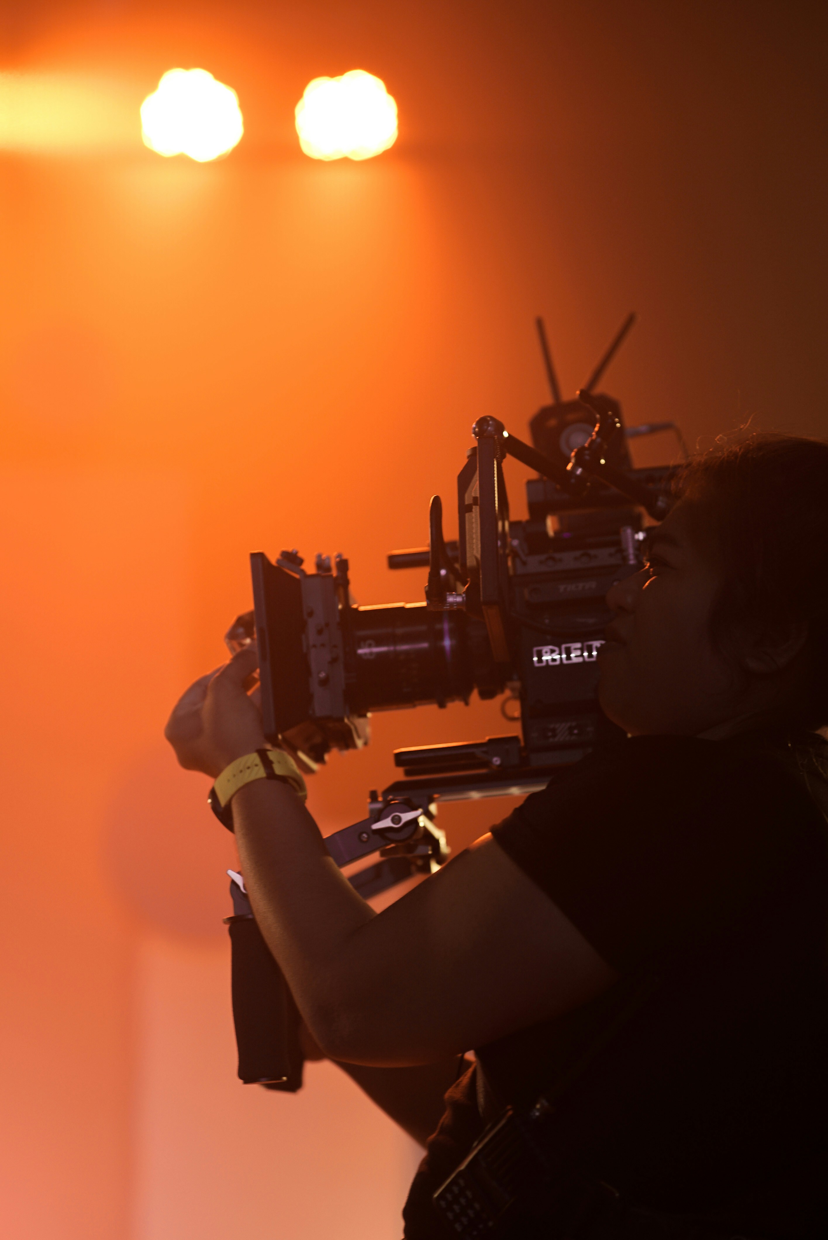 Woman using professional video camera photo Free Orange Image on Unsplash