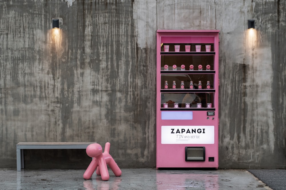pink toy beside pink Zapangi vending machine