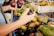 Bright yellow passion fruits spilling out of a rustic basket on a market table.