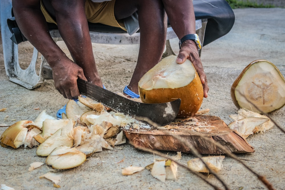 person slicing coconut