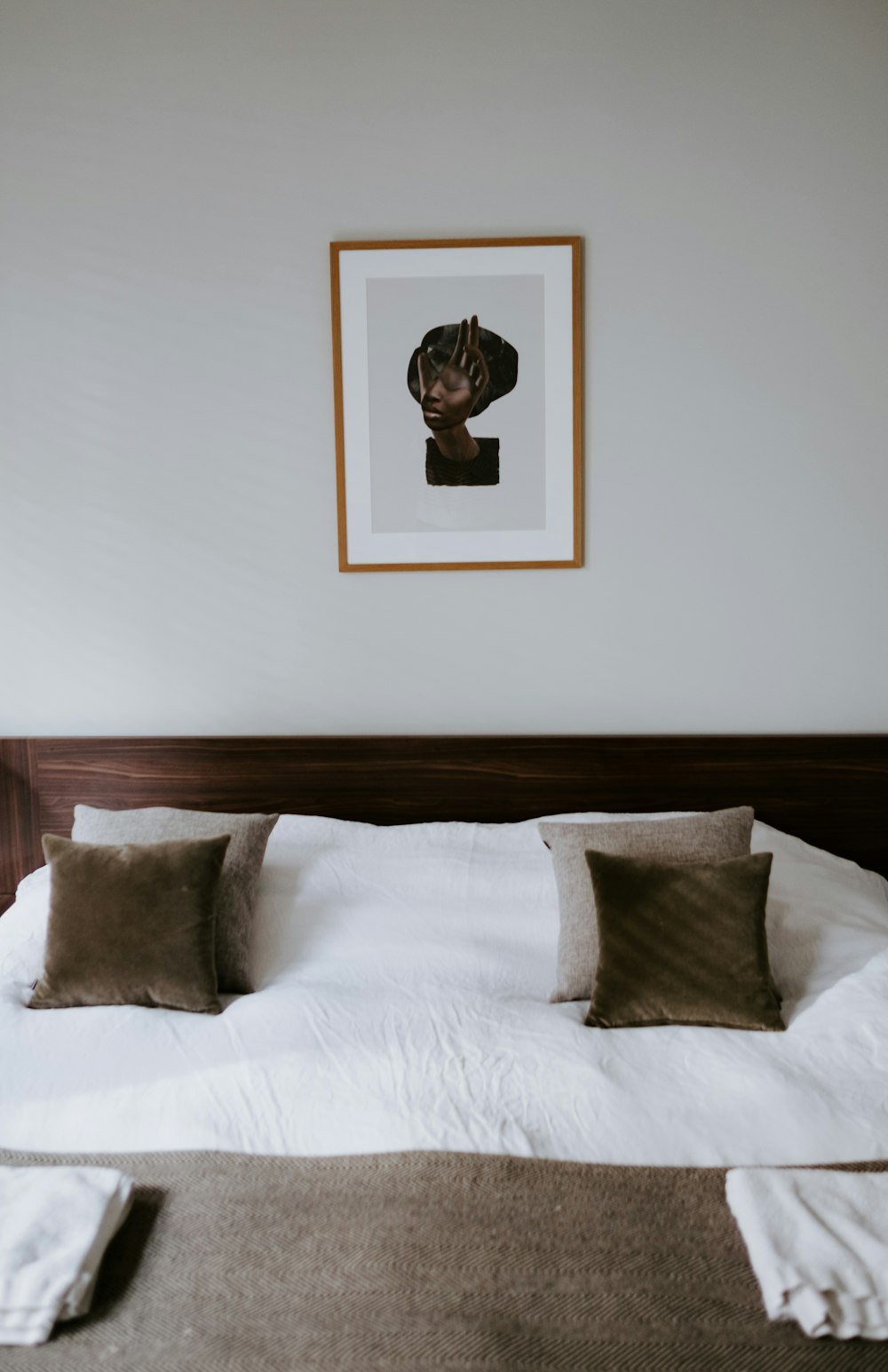 white and brown bedspread set inside bedroom