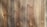 Four wooden planks with visible grain patterns and knots, characterized by a natural brown color and varied texture.