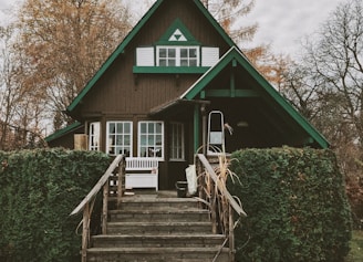 brown and green painted house