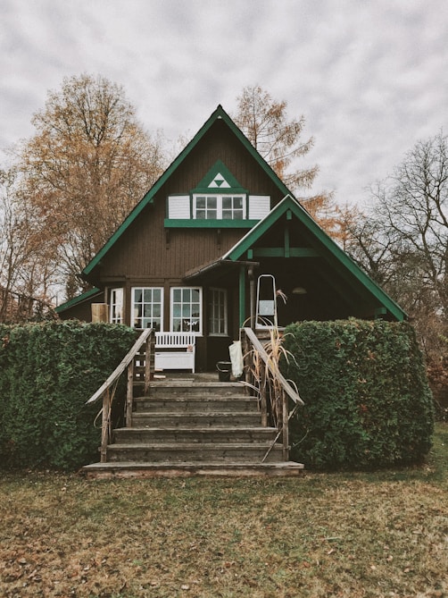 brown and green painted house