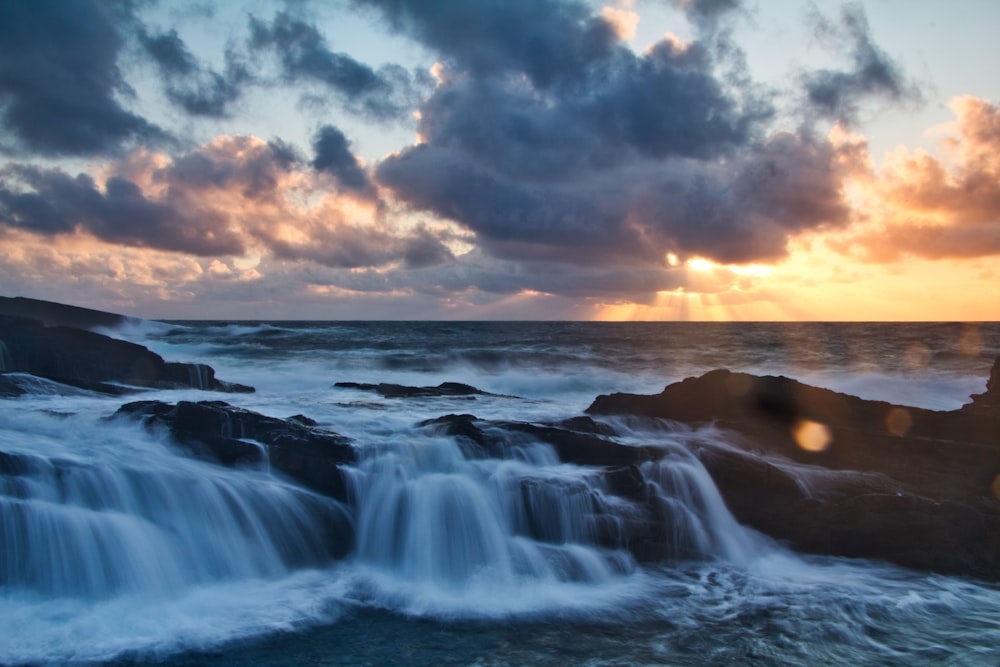 time-lapse photography of water flowing on rocks