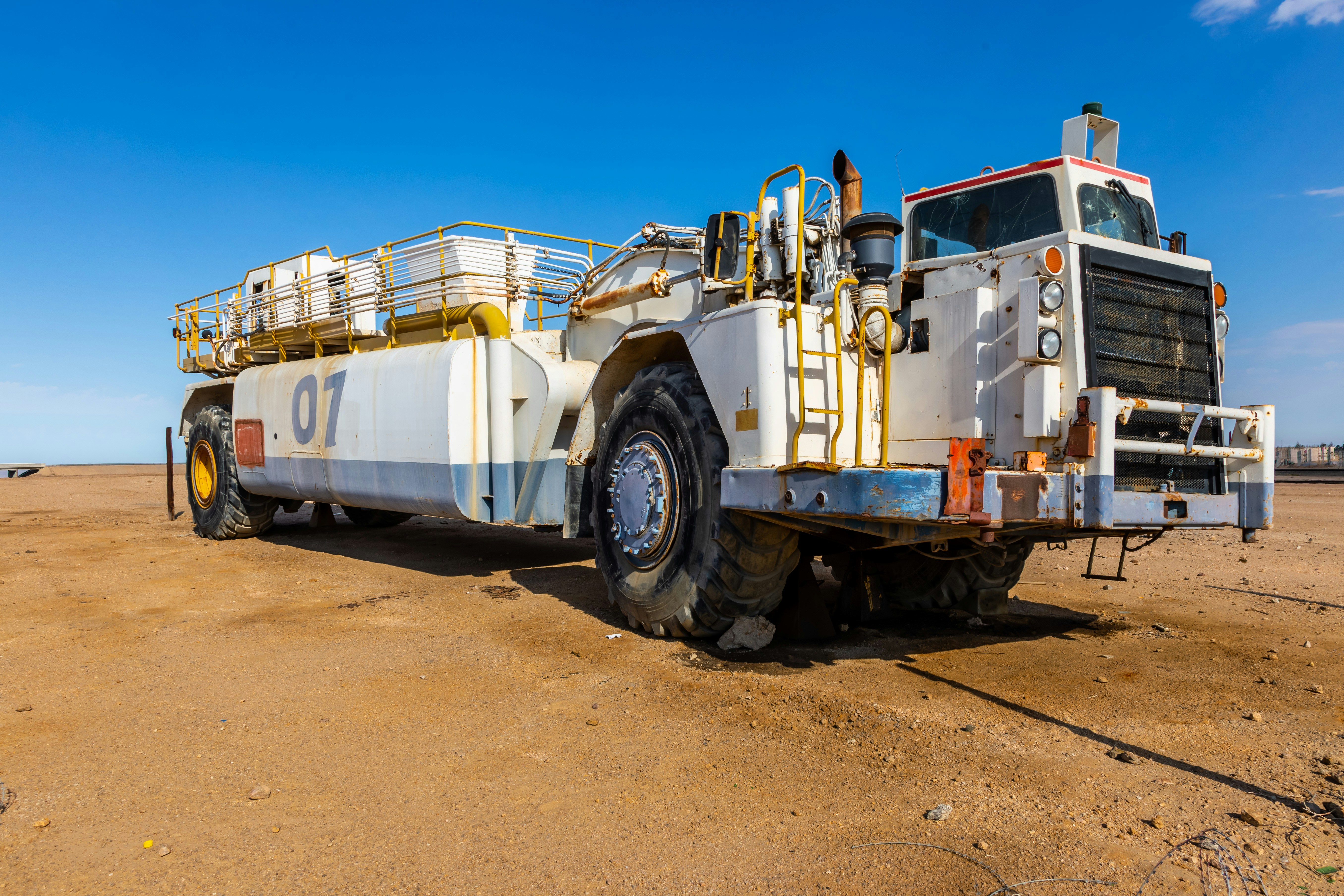 a large truck parked on top of a dirt field