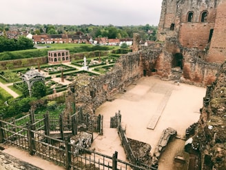 A picturesque view of ancient ruins in a lush green setting.