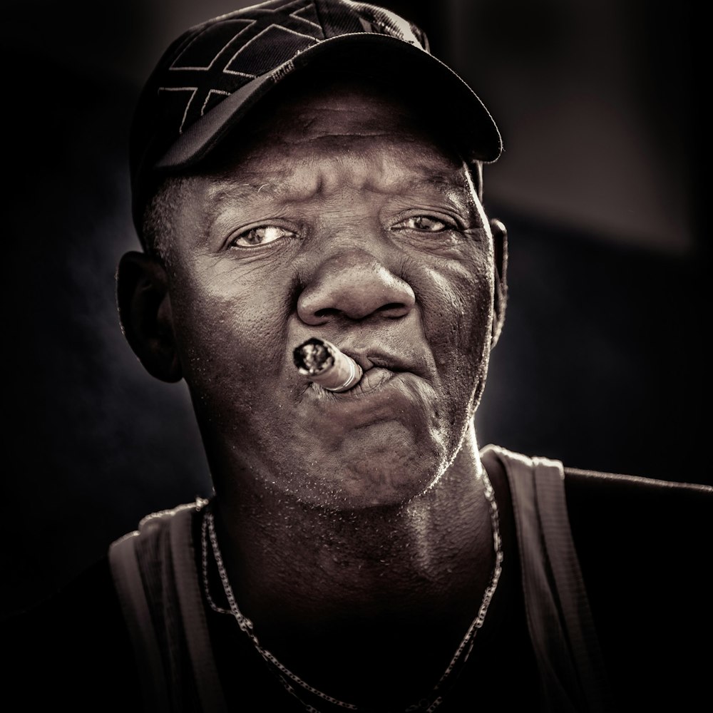 portrait photography of man smoking cigar
