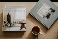brown ceramic mug near two books