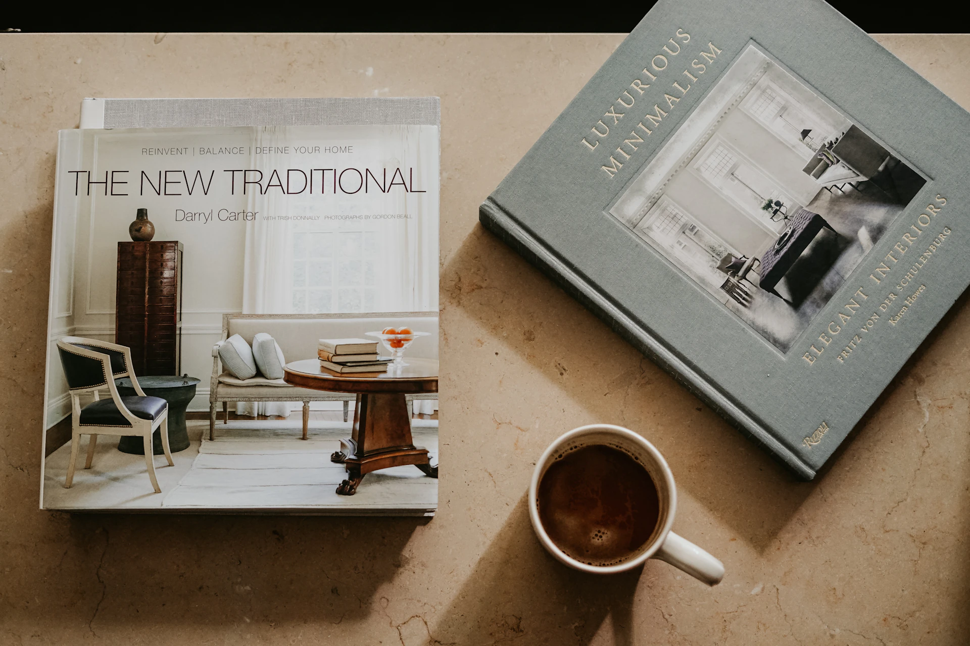 brown ceramic mug near two books