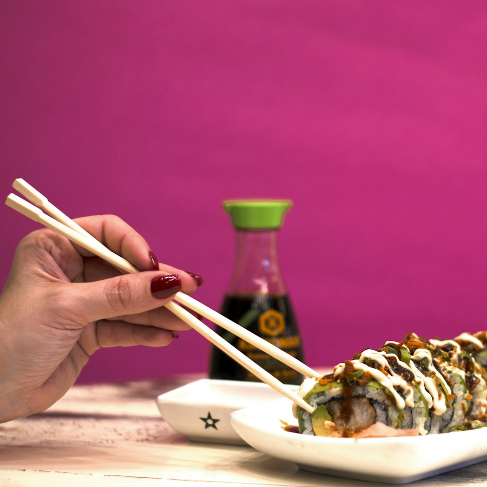 person using chopstick on cooked food