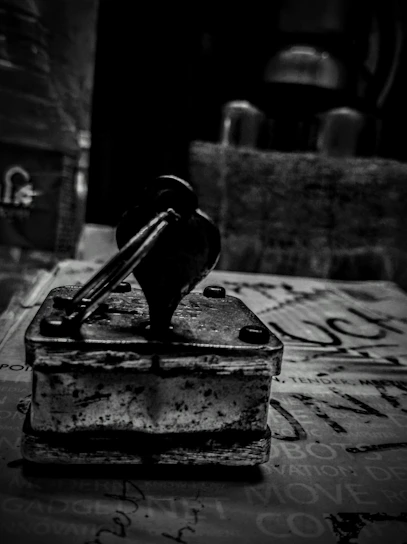 Close-up of a hand holding a vintage USPS stamp against a wooden desk background.