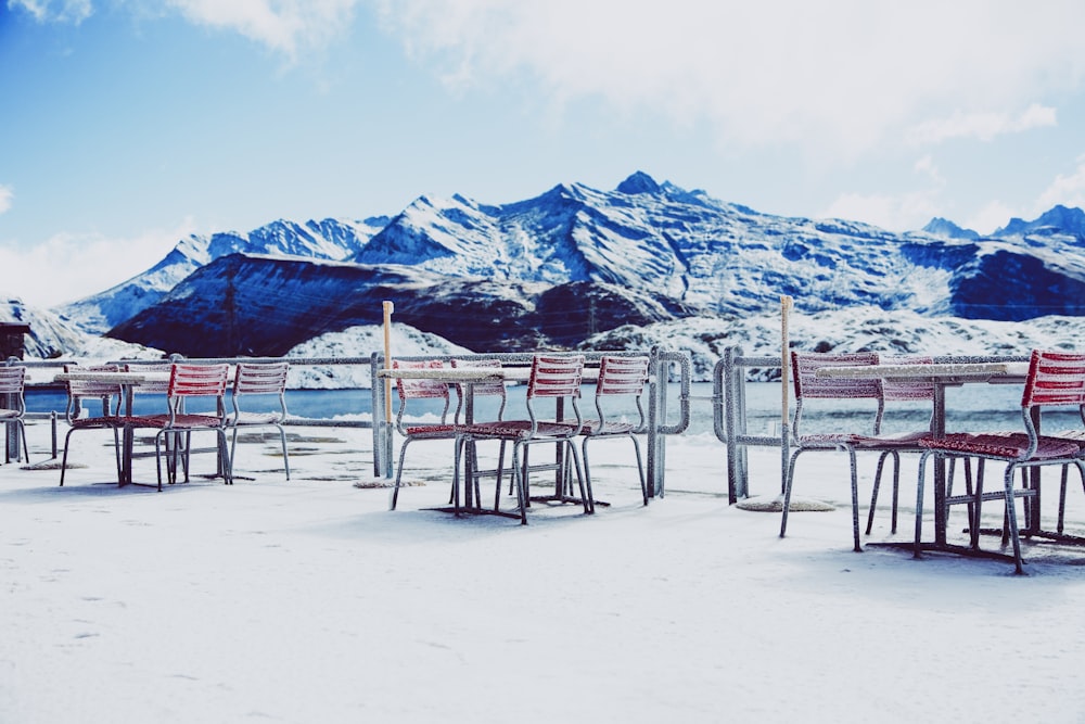 brown wooden table beside chairs near rocky mountain