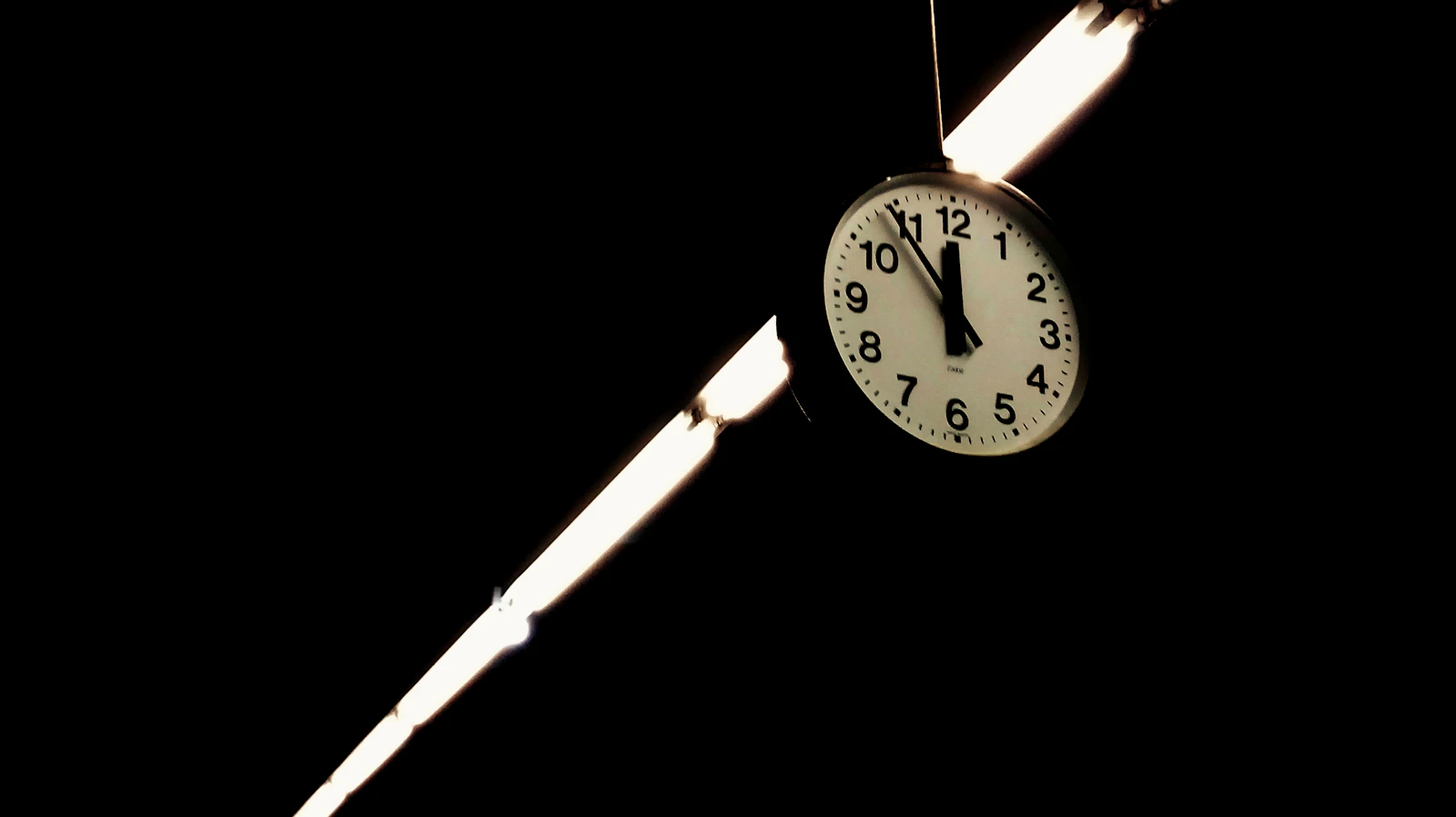 The brass pendulum and gears of an old clock mechanism, stopped mid-swing