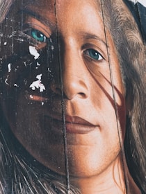 A close-up of a detailed handcrafted painting capturing the essence of a person's face.