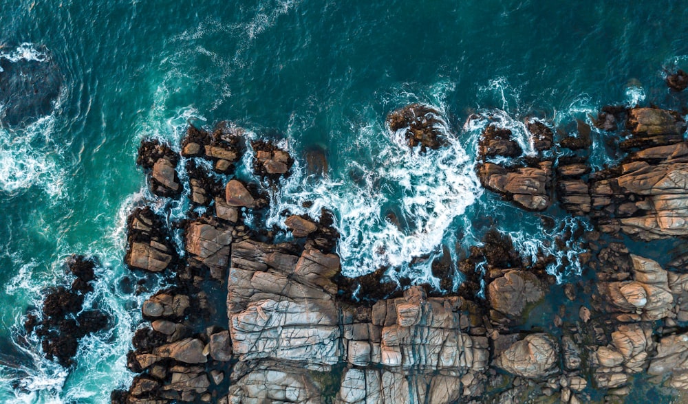 aerial photography of rock formation near sea