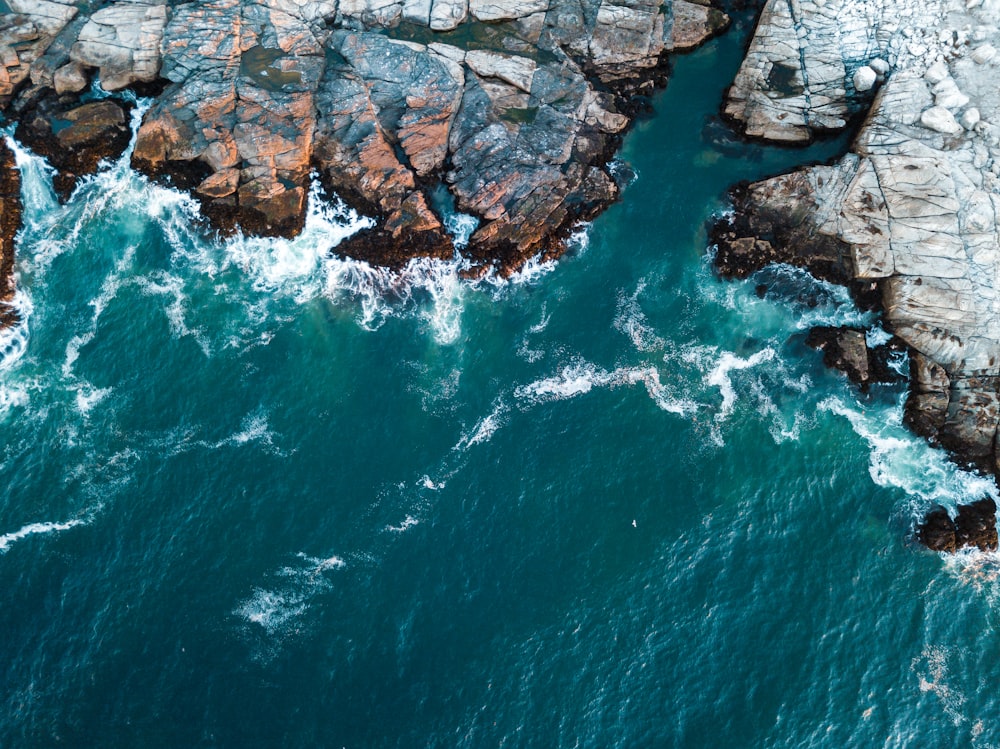 rock formation in front of body of water