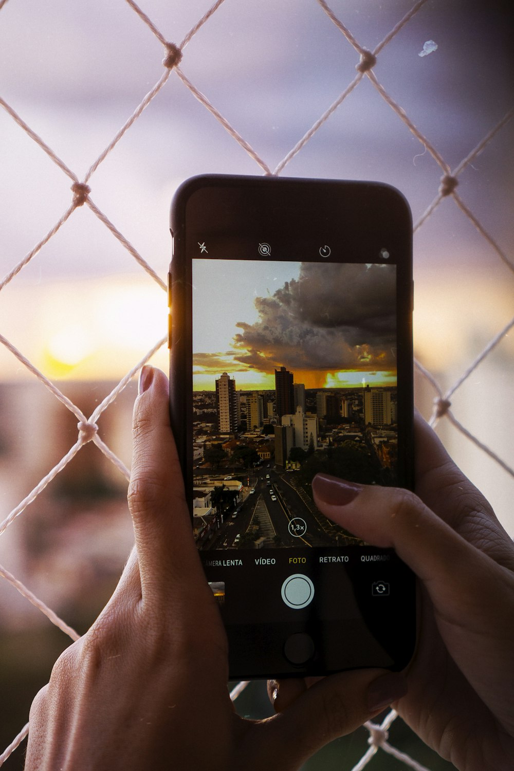 person holding smartphone capturing city in closed-up photography