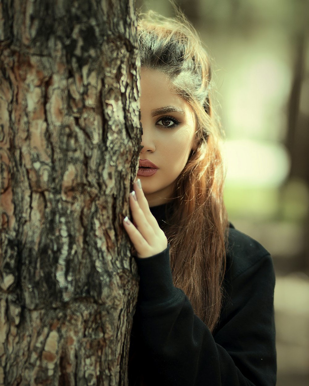 woman holding tree