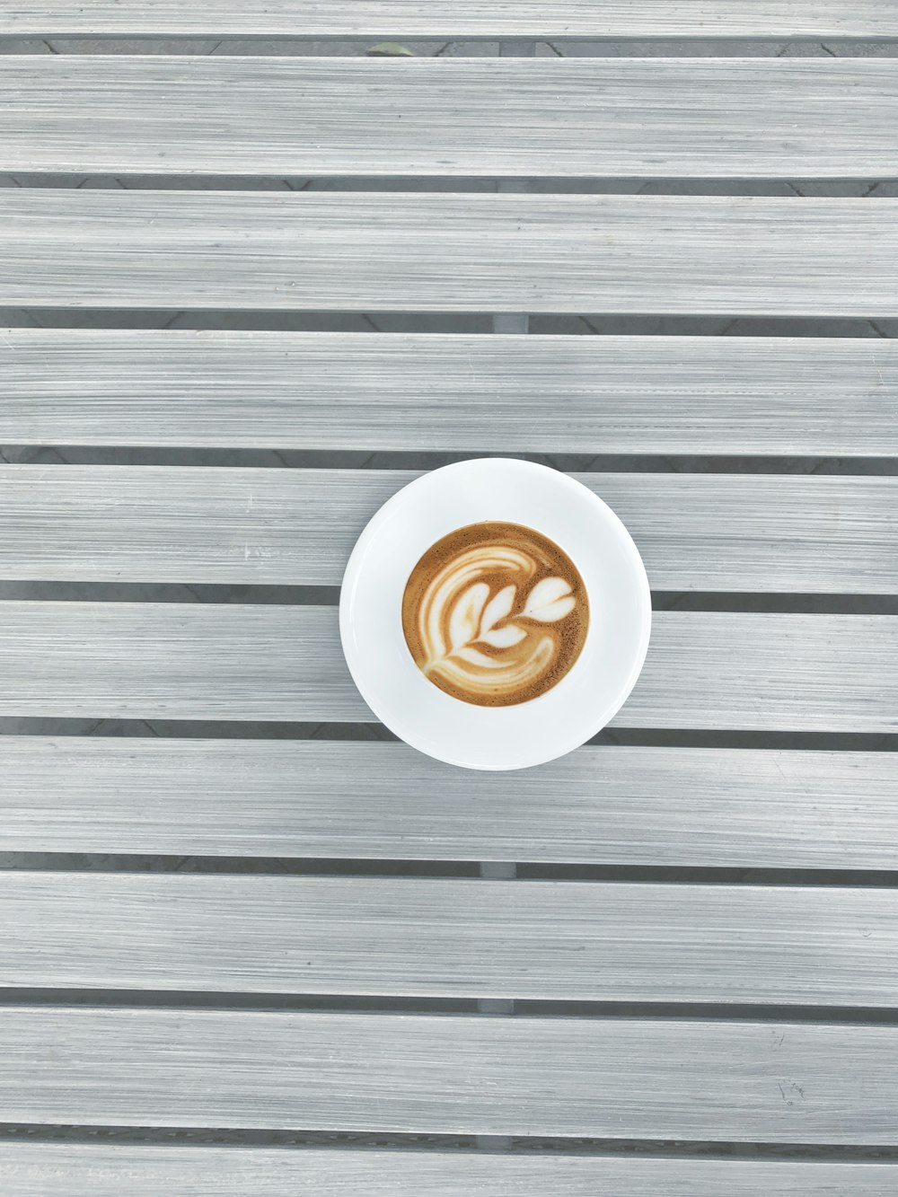 round white espresso coffee on grey striped surface