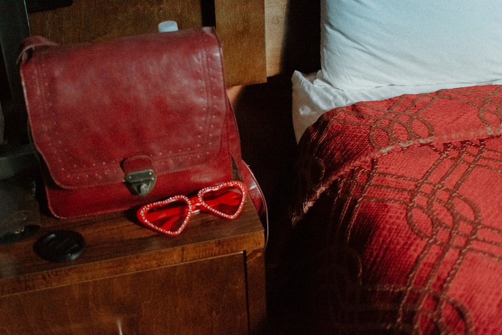 red leather bag on brown nightstand