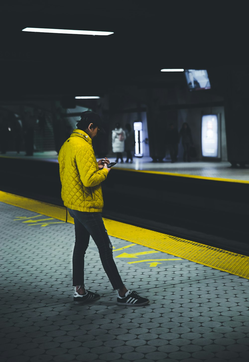 man standing wearing yellow jacket