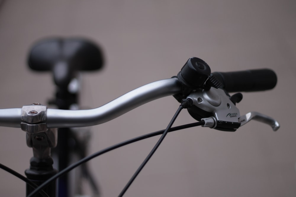 selective-focus photograph of silver bike handlebar