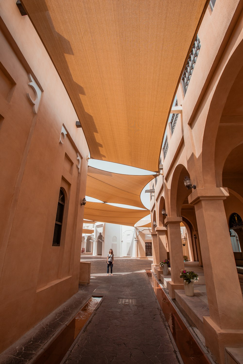 a person standing under a large shade structure