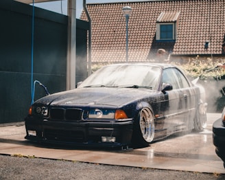 black BMW E36 on car wash