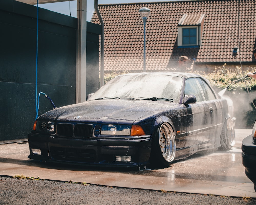 black BMW E36 on car wash