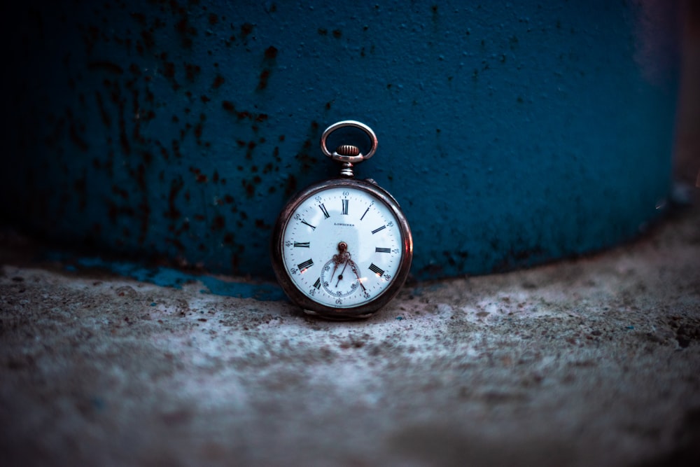 shallow focus photo of silver-colored pocket watch