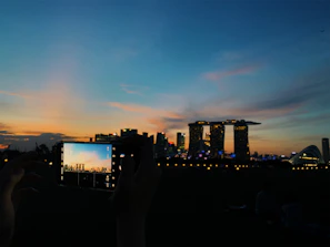 Traveler capturing a sunset photo in a vibrant international city