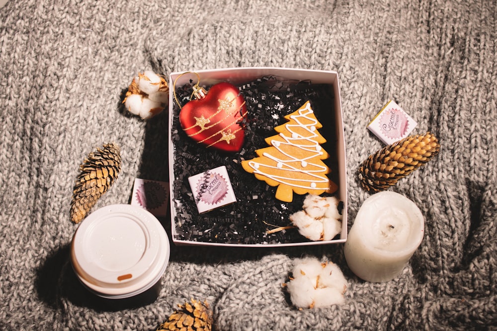 pinetree and baubles in box with white pillar candle