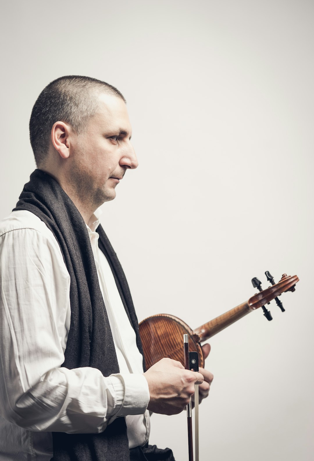 man holding brown violin