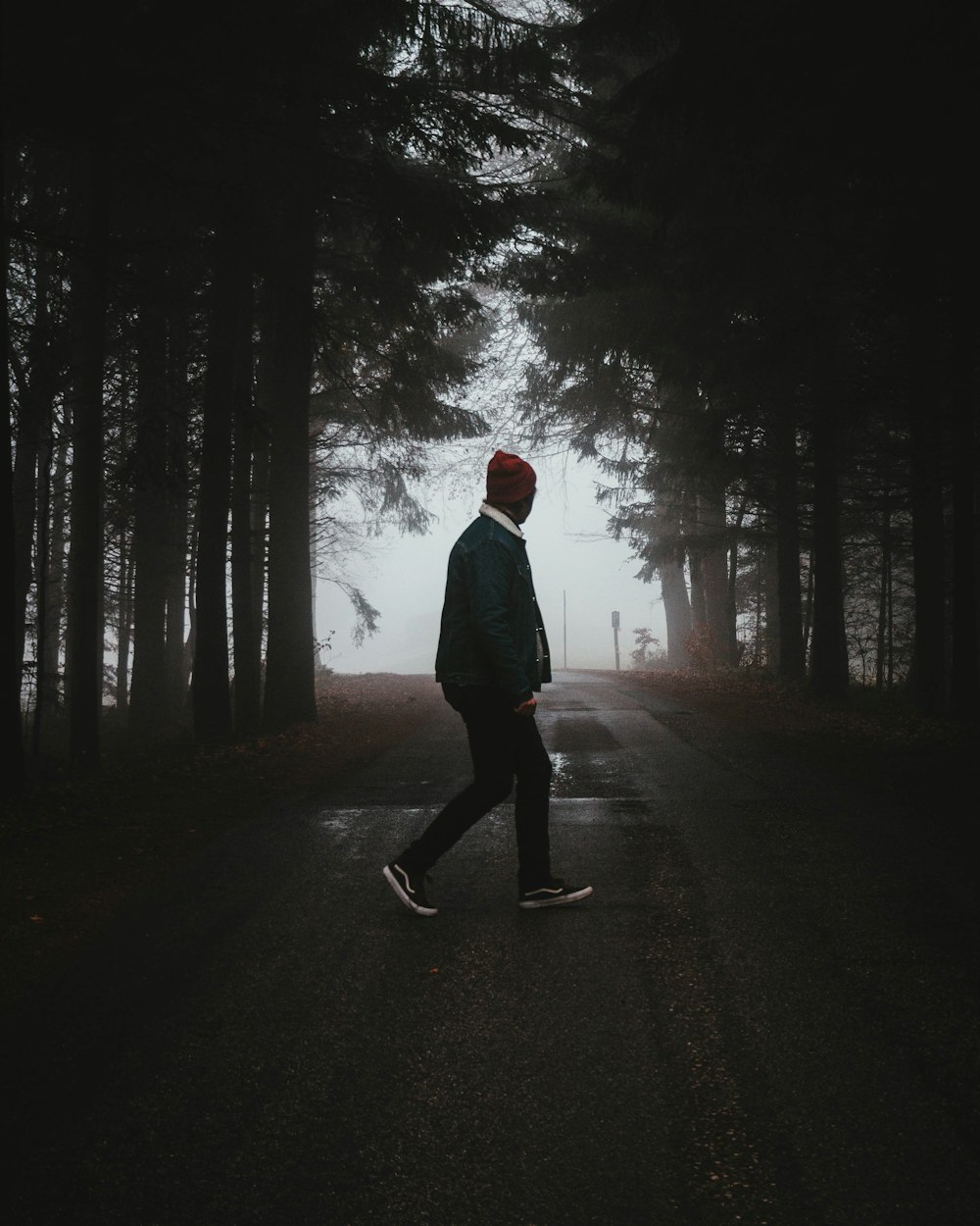 man walking on road