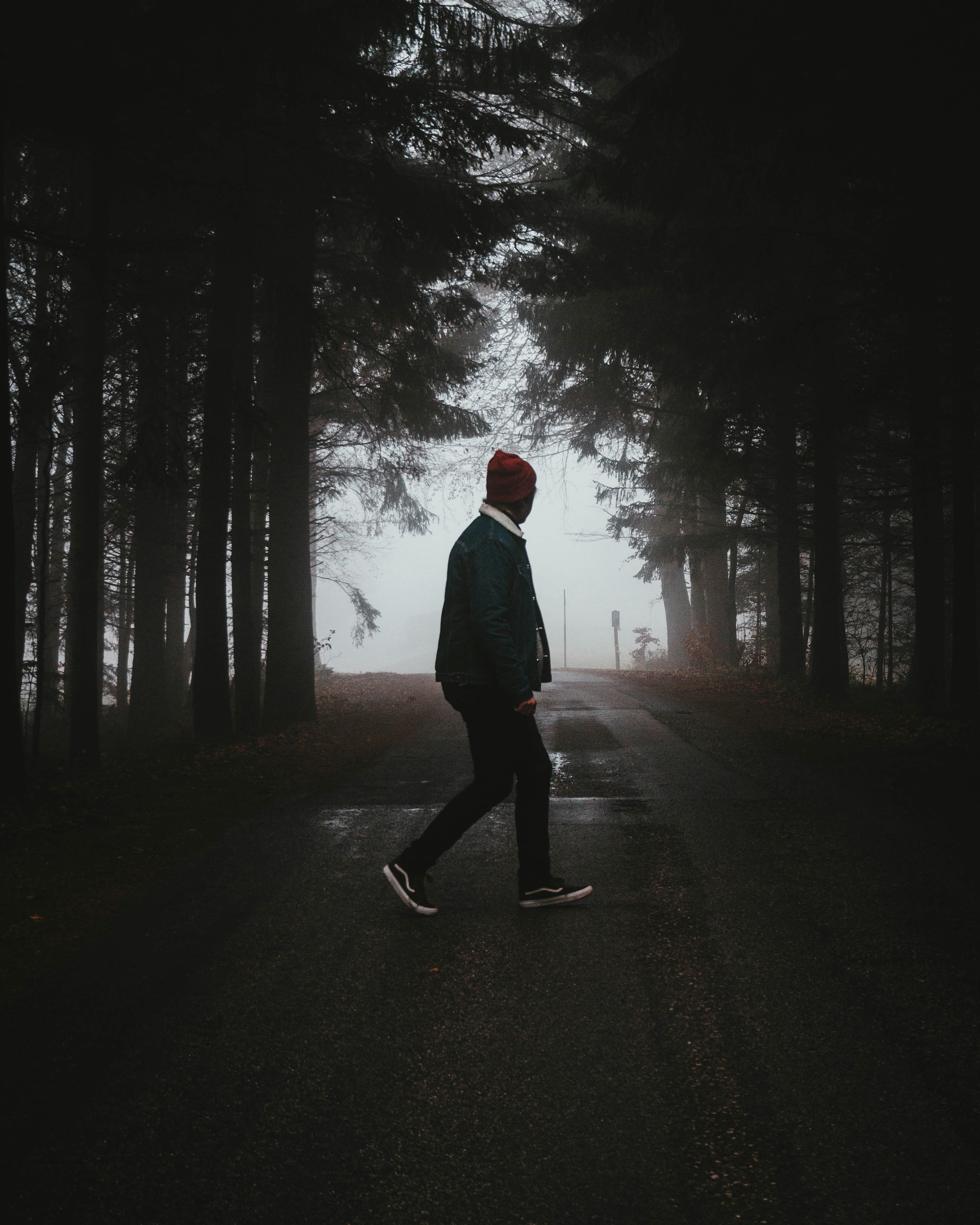 man walking on road