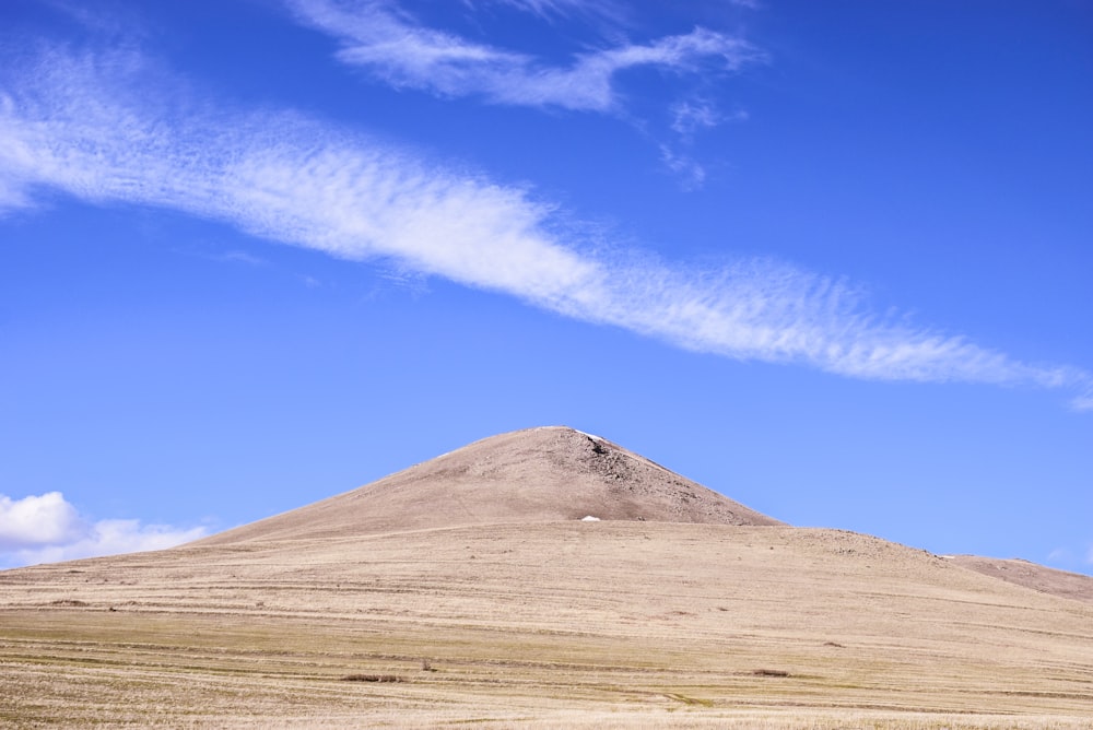 brown mountain under blue sky