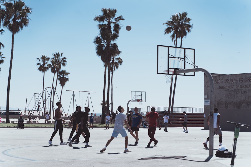men playing basketball during day