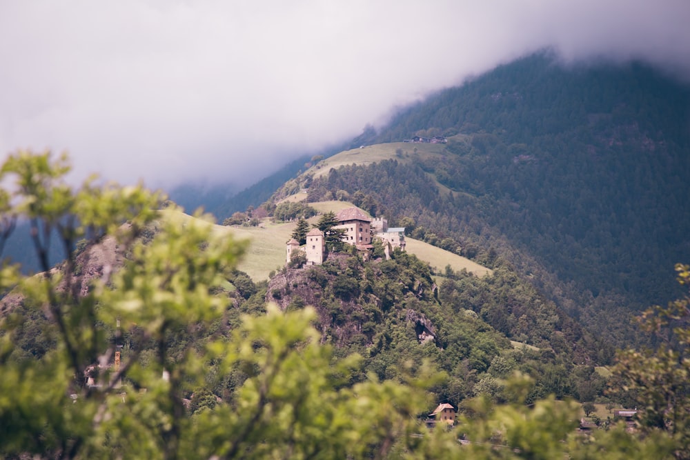 aerial photography of mountain with house on top