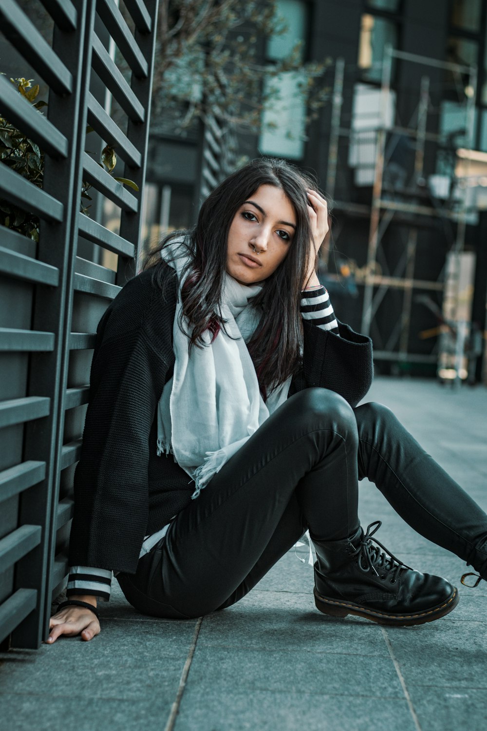 selective focus photo of woman sitting on pavement