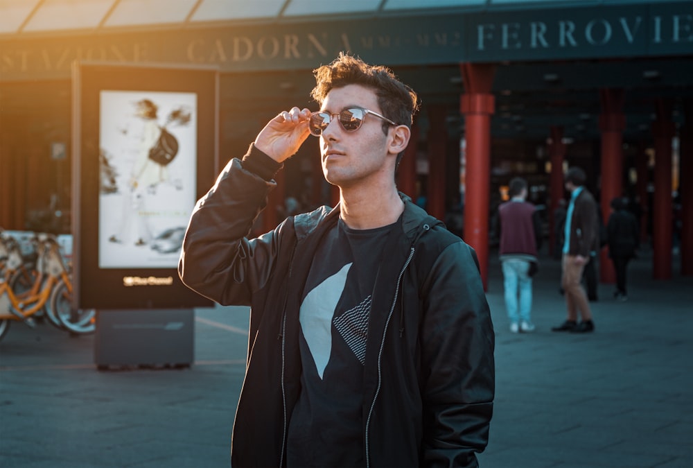 man in black zip-up jacket wearing sunglasses